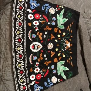 Black mini skirt w/embroidery on front /back  L